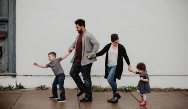 children holding hands with their parents