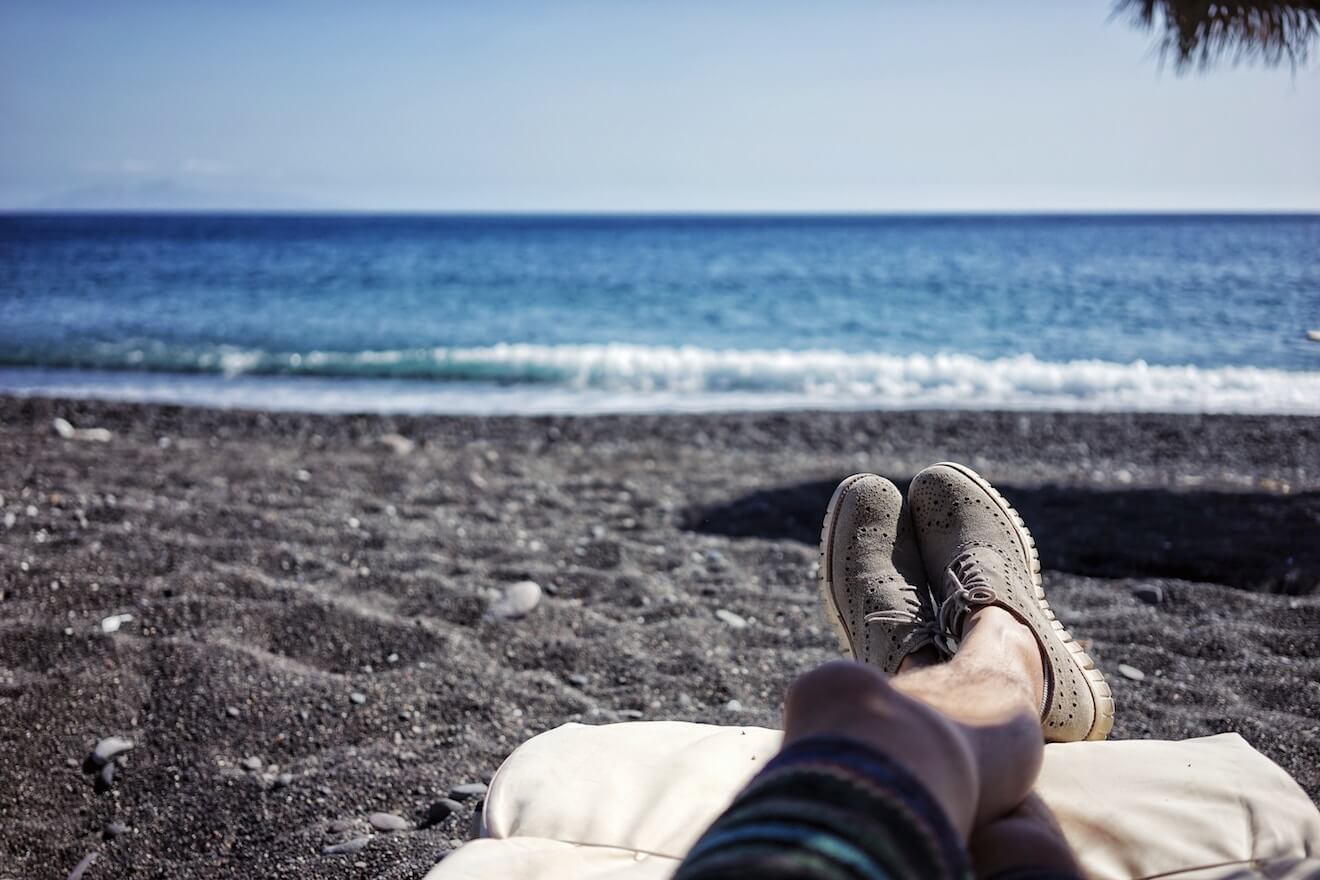 Person sitting by the ocean