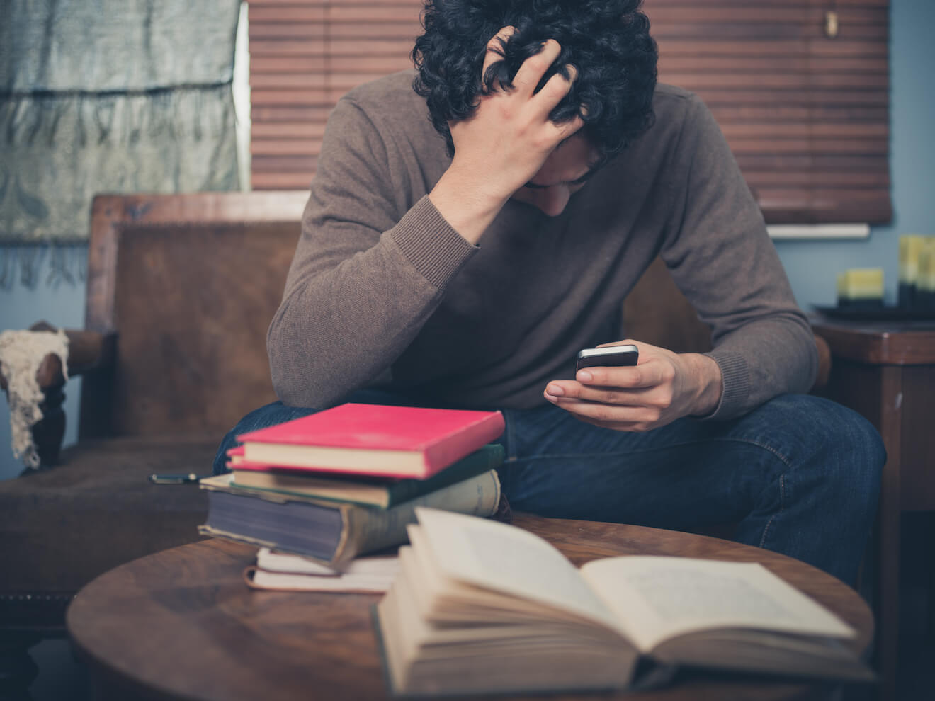 Attractive man confronting bad news on his phone